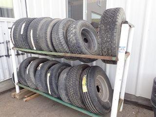 Lot of 2 Tier Tire Rack and Approx. 15 Asst. Size Tires.